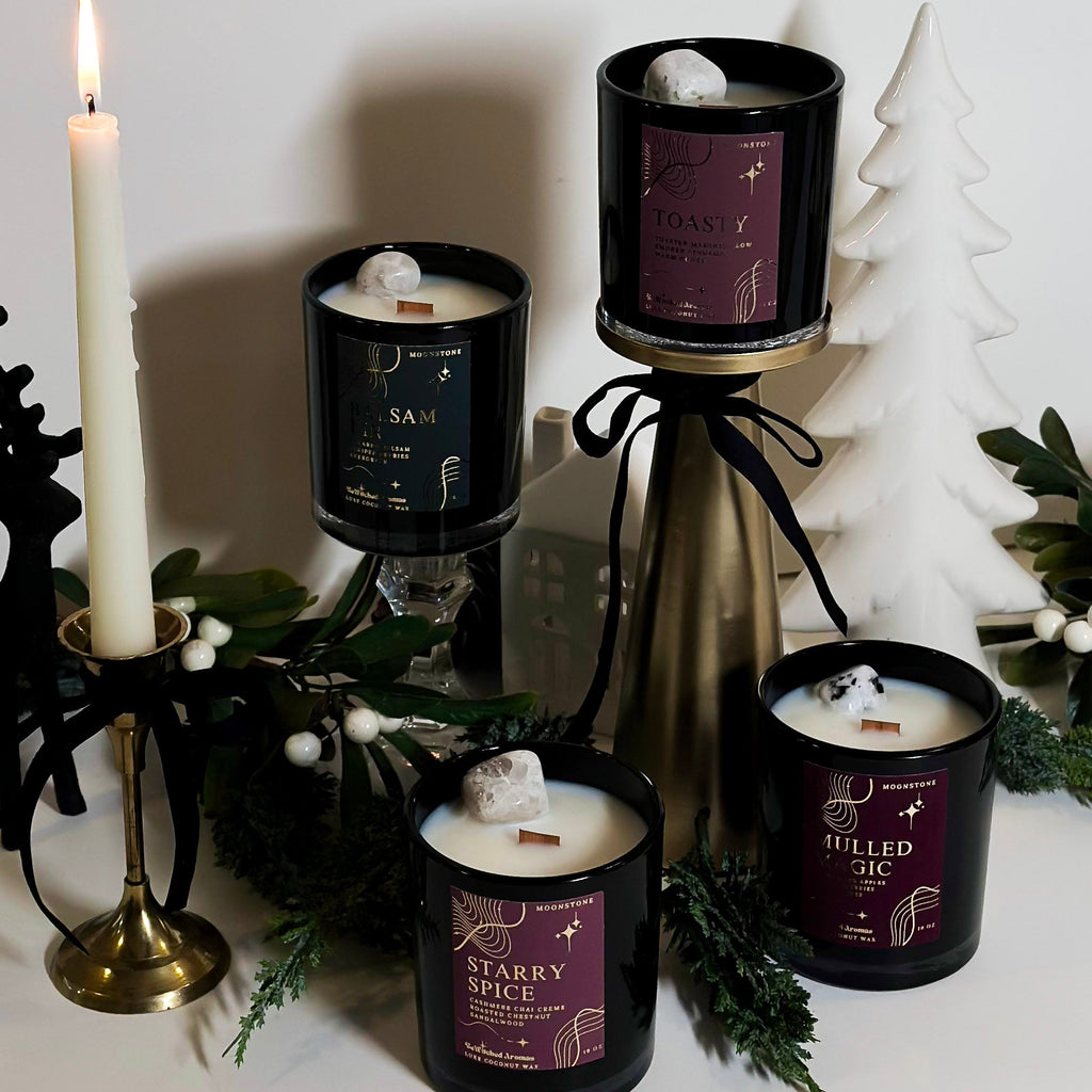 Collection of christmas candles with decorative elements on a white surface